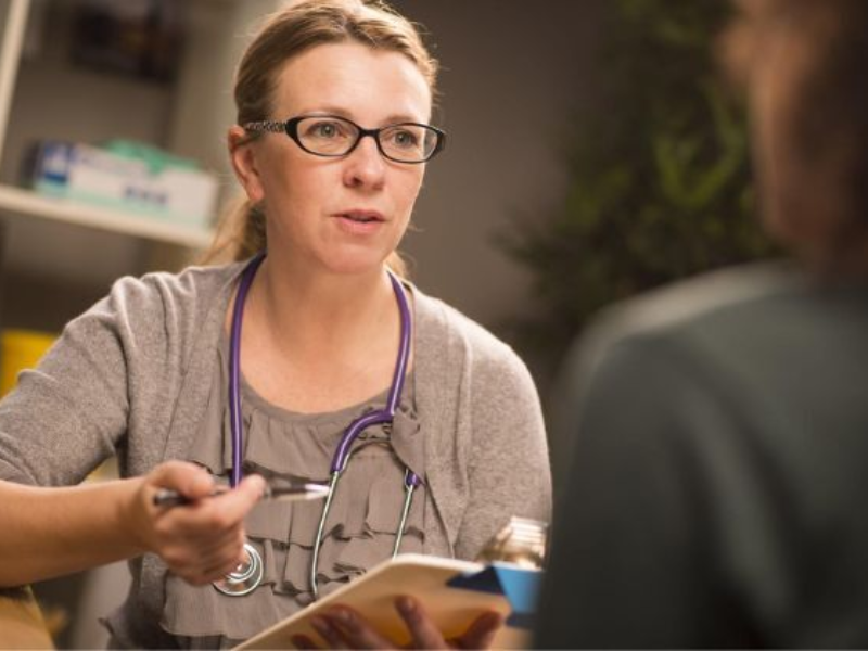 A health professional consults with a patient