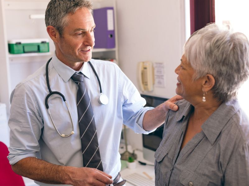 A male doctor consults with a female patient