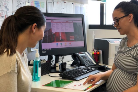 A female health professional consults with a female patient