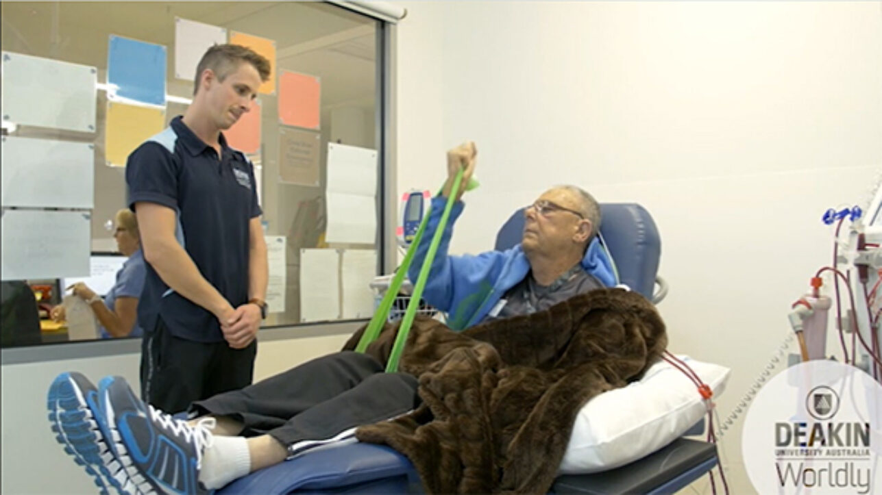 A health professional supports a dialysis patient